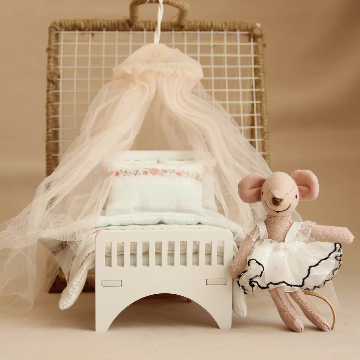 Miniature wooden bed with fabric bedings